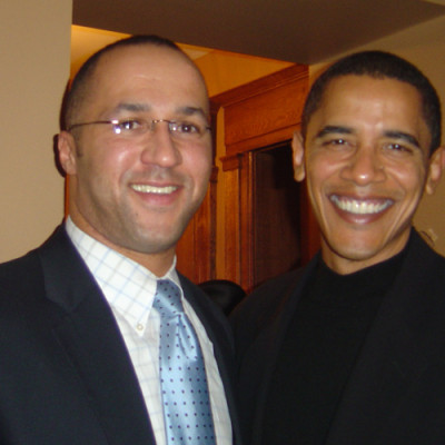 Mike Laux celebrating with then-U.S. Senator Barack Obama at a 2006 holiday party. Throughout the night, Mike urged Senator Obama to run for President.